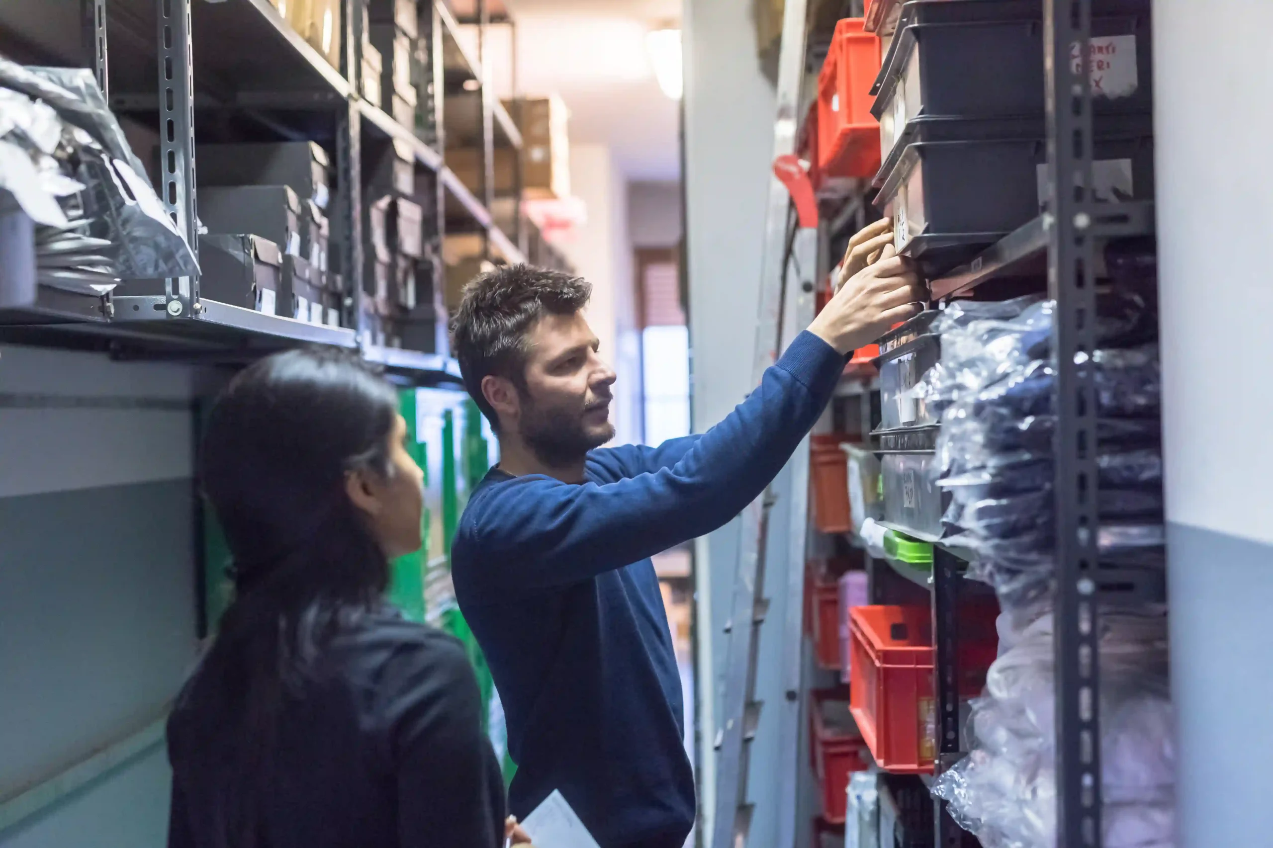 Staff organizing labeled containers and checking shelf inventory by SKU as part of inventory management 101 setup