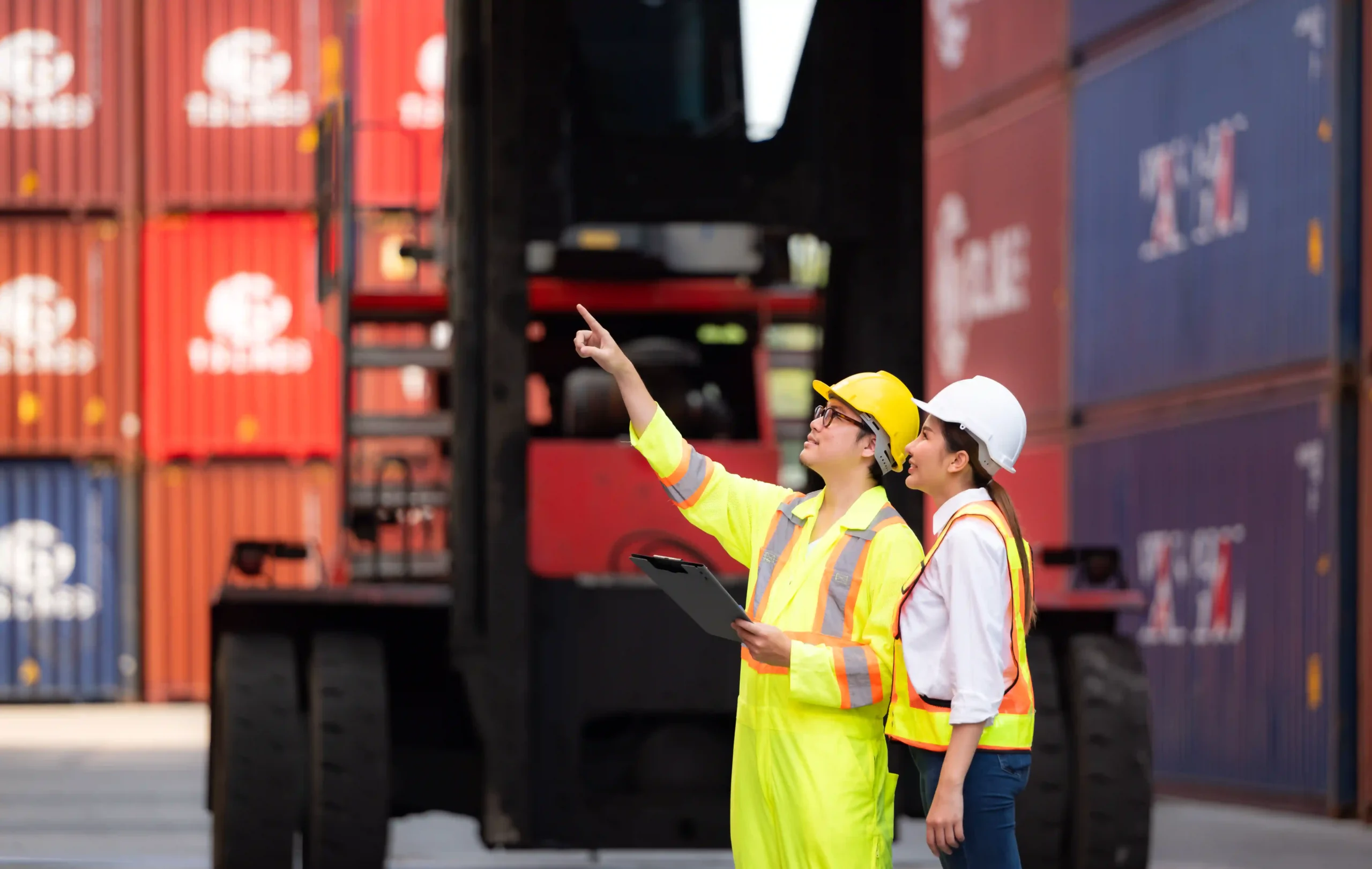 Logistics and forwarding company professionals reviewing cargo operations at an international shipping yard