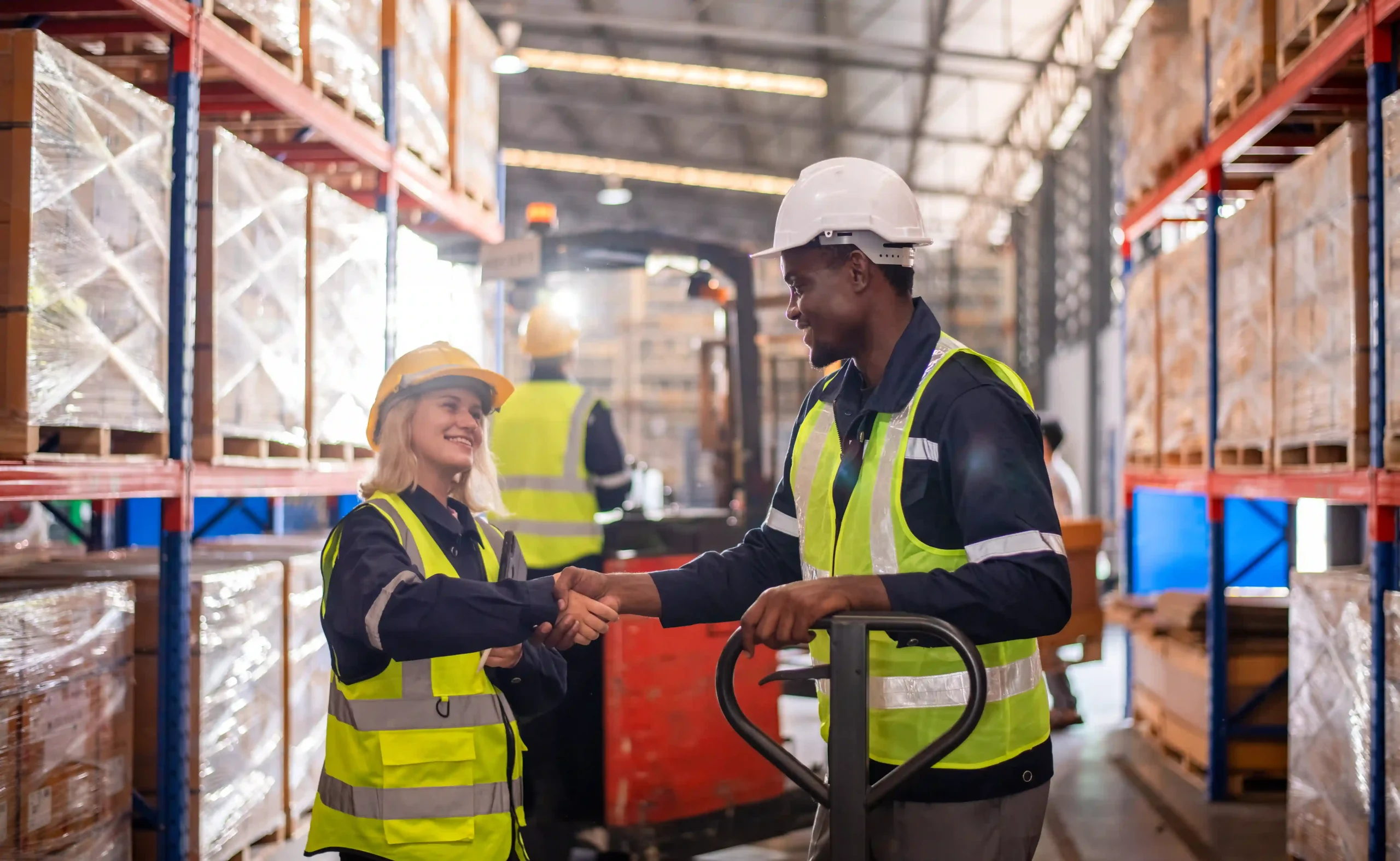 Warehouse staff shaking hands after completing a global trade compliance certification readiness audit