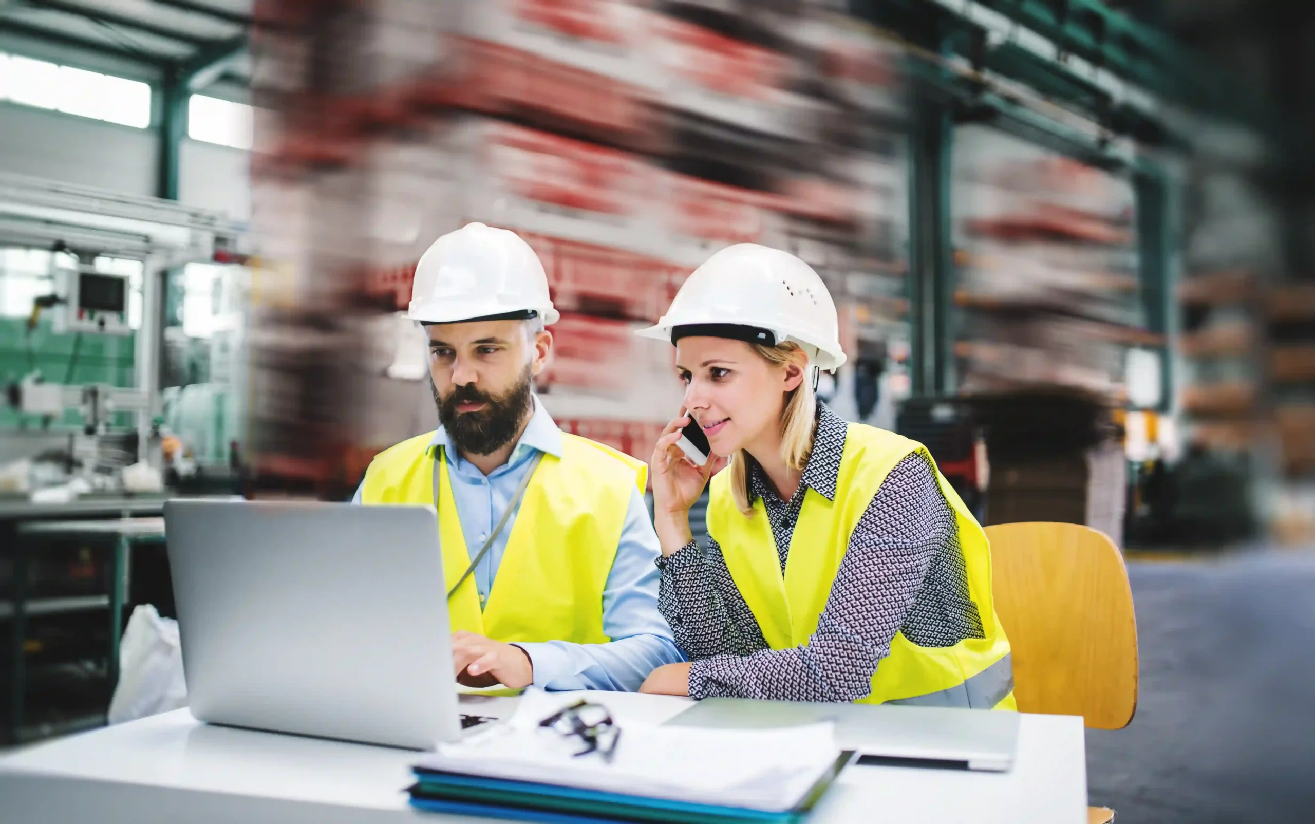 Industrial professionals analyzing safety reports on site, aligning operations with de minimis OSHA compliance standards.