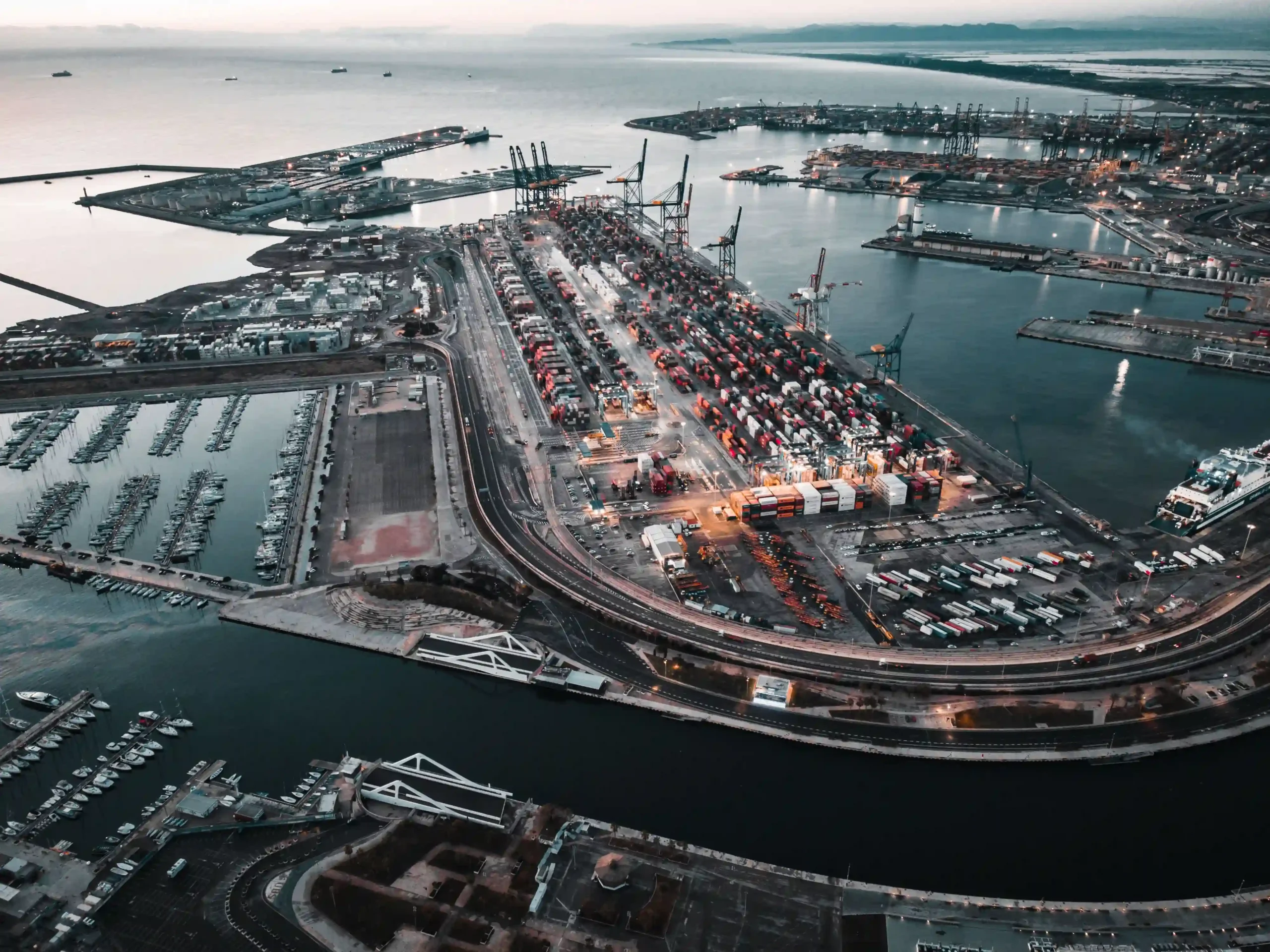 Aerial view of international shipping port illustrating global trade logistics and what is de minimis safe harbor.