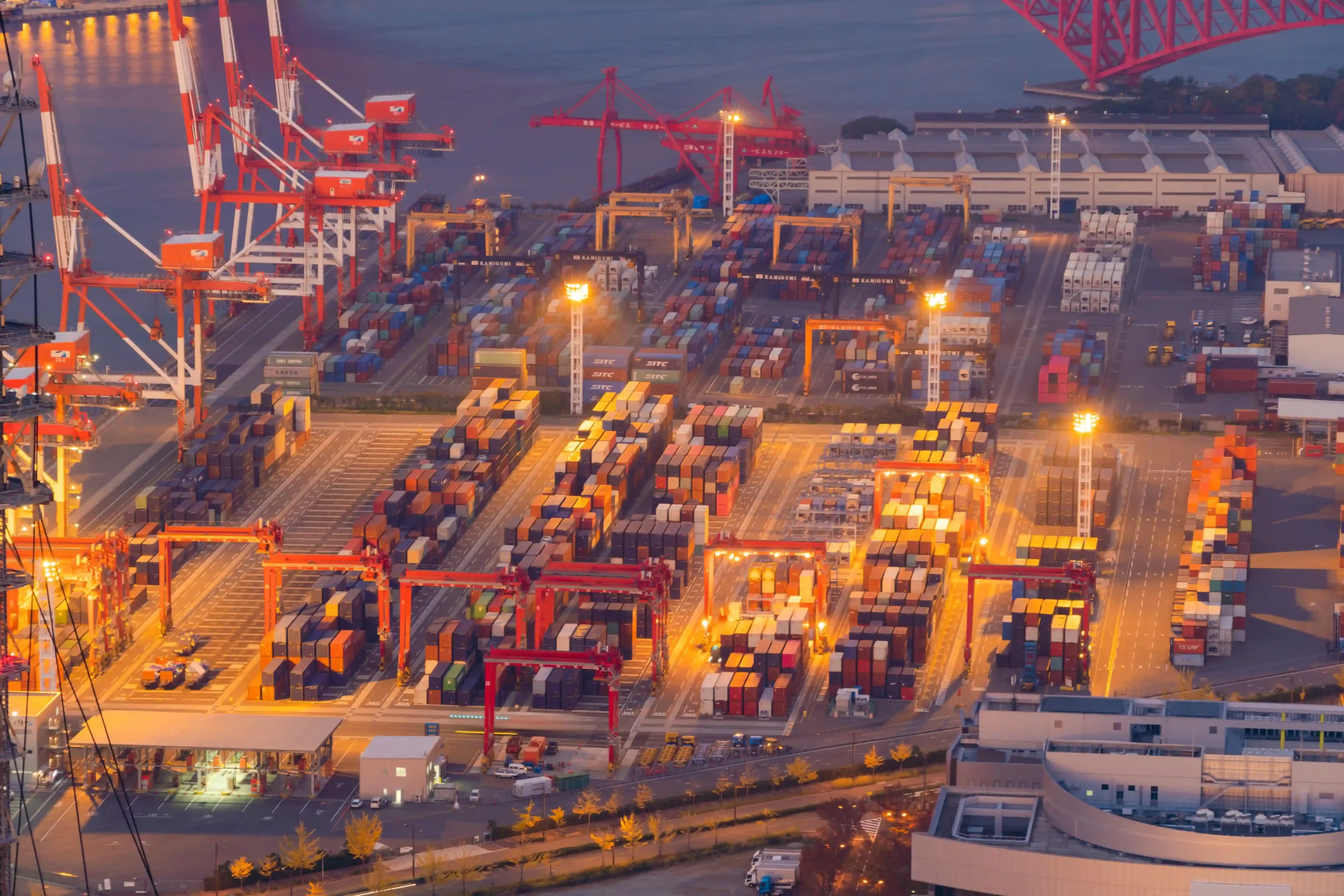 Busy container terminal at night showing cargo operations linked to what is de minimis safe harbor rules.