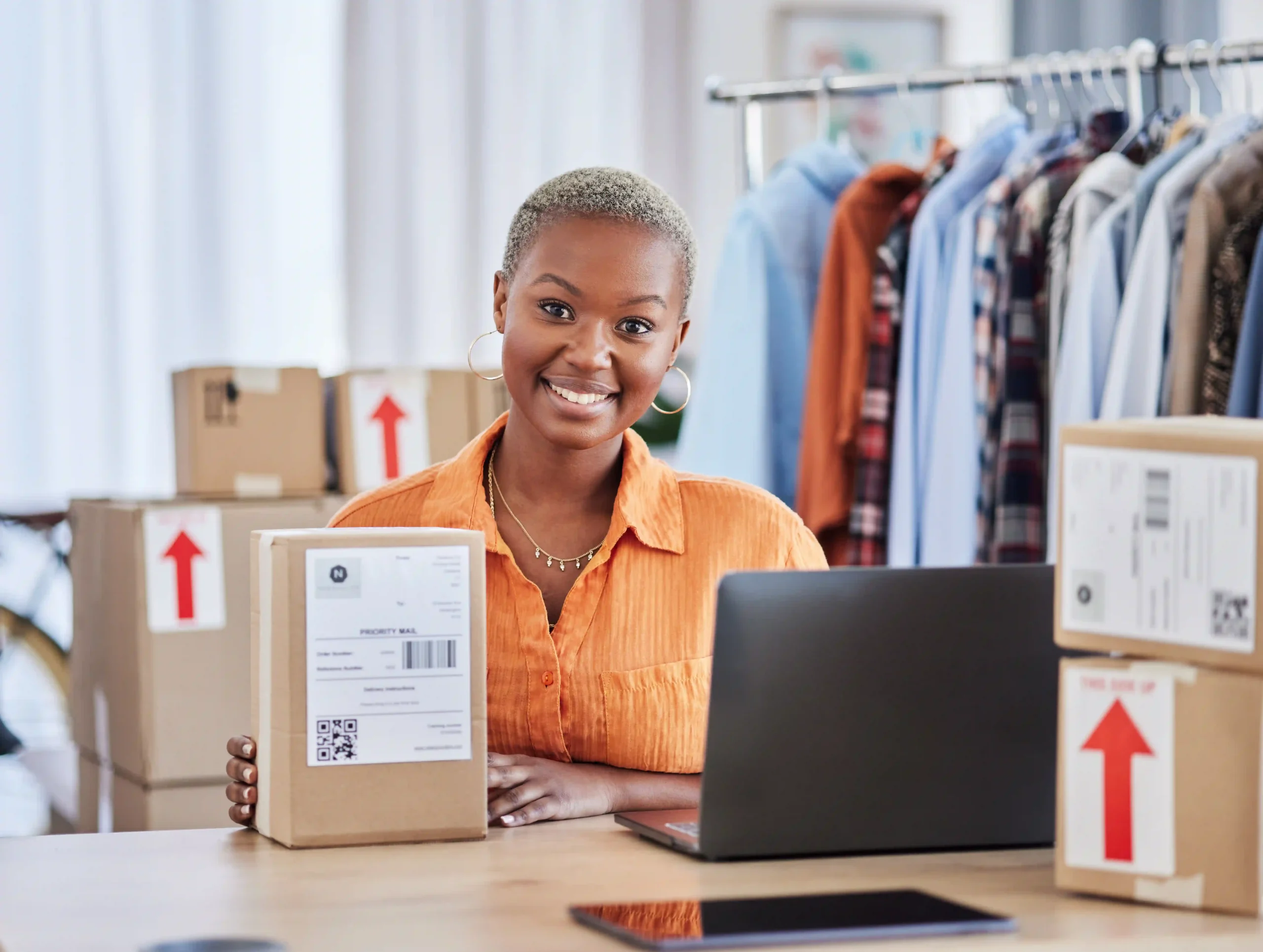 Fashion entrepreneur with packages ready for shipping, adapting business to what is the de minimis exemption changes.