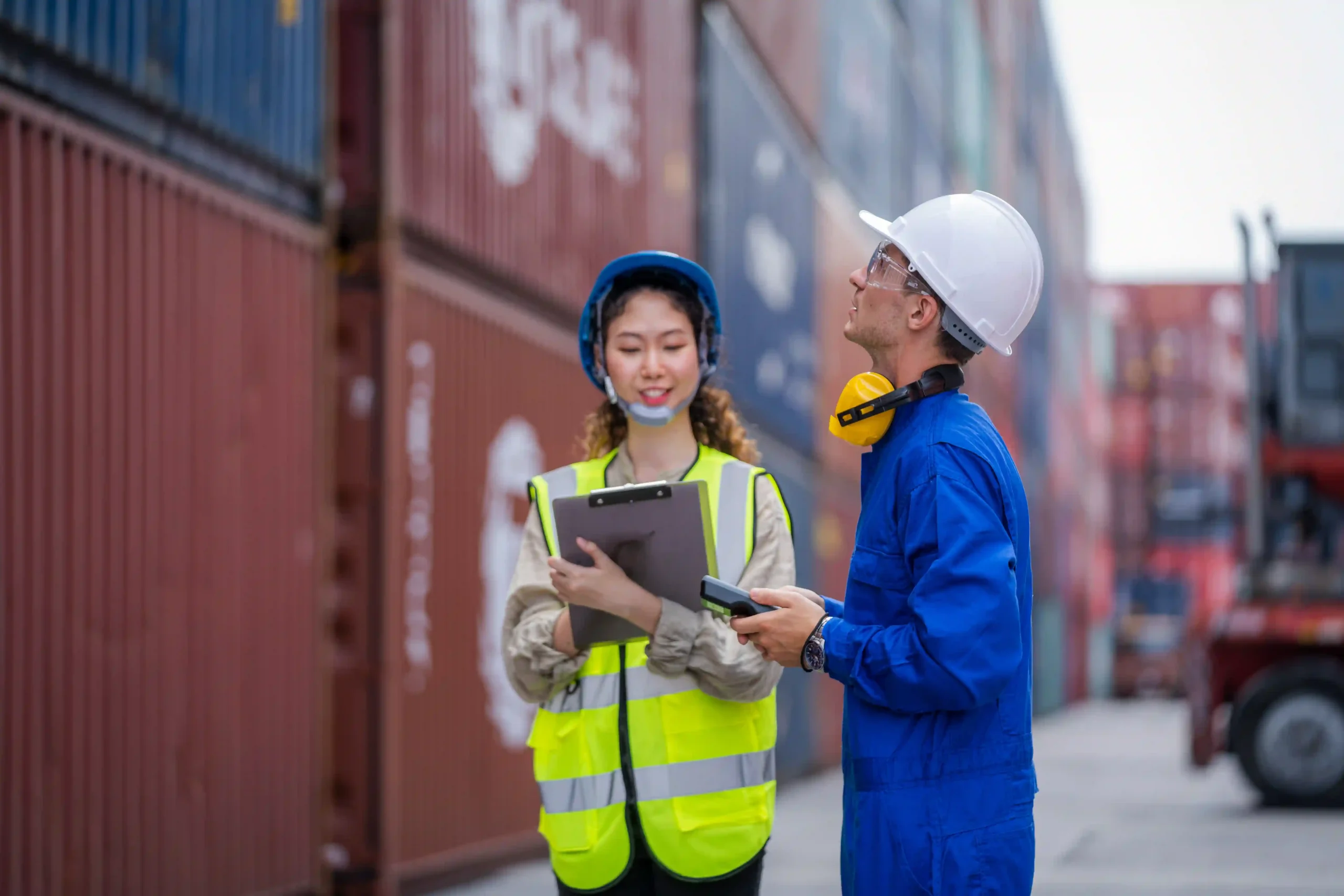 Inspectors checking cargo containers and reviewing customs documentation under the us de minimis rule changes.