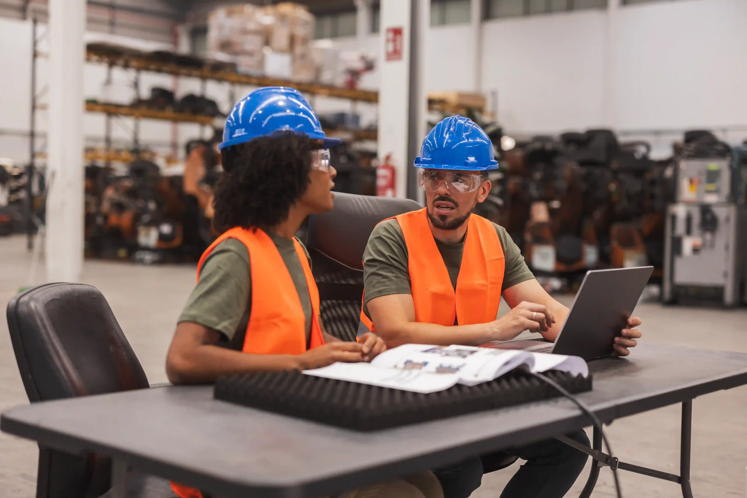 Engineers collaborating on safety documentation and compliance reviews, showing how de minimis OSHA is applied in planning.