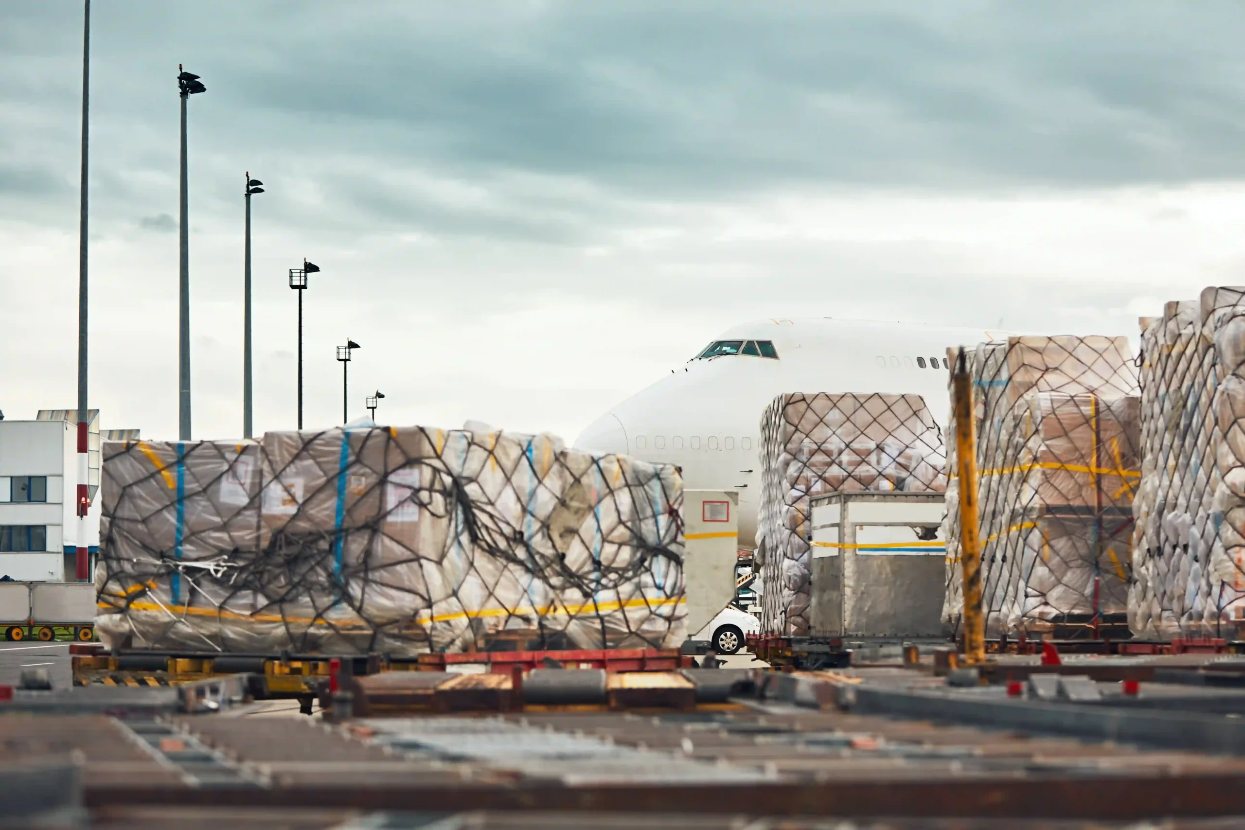 International cargo at airport showing how what is de minimis in tax affects global imports and logistics.