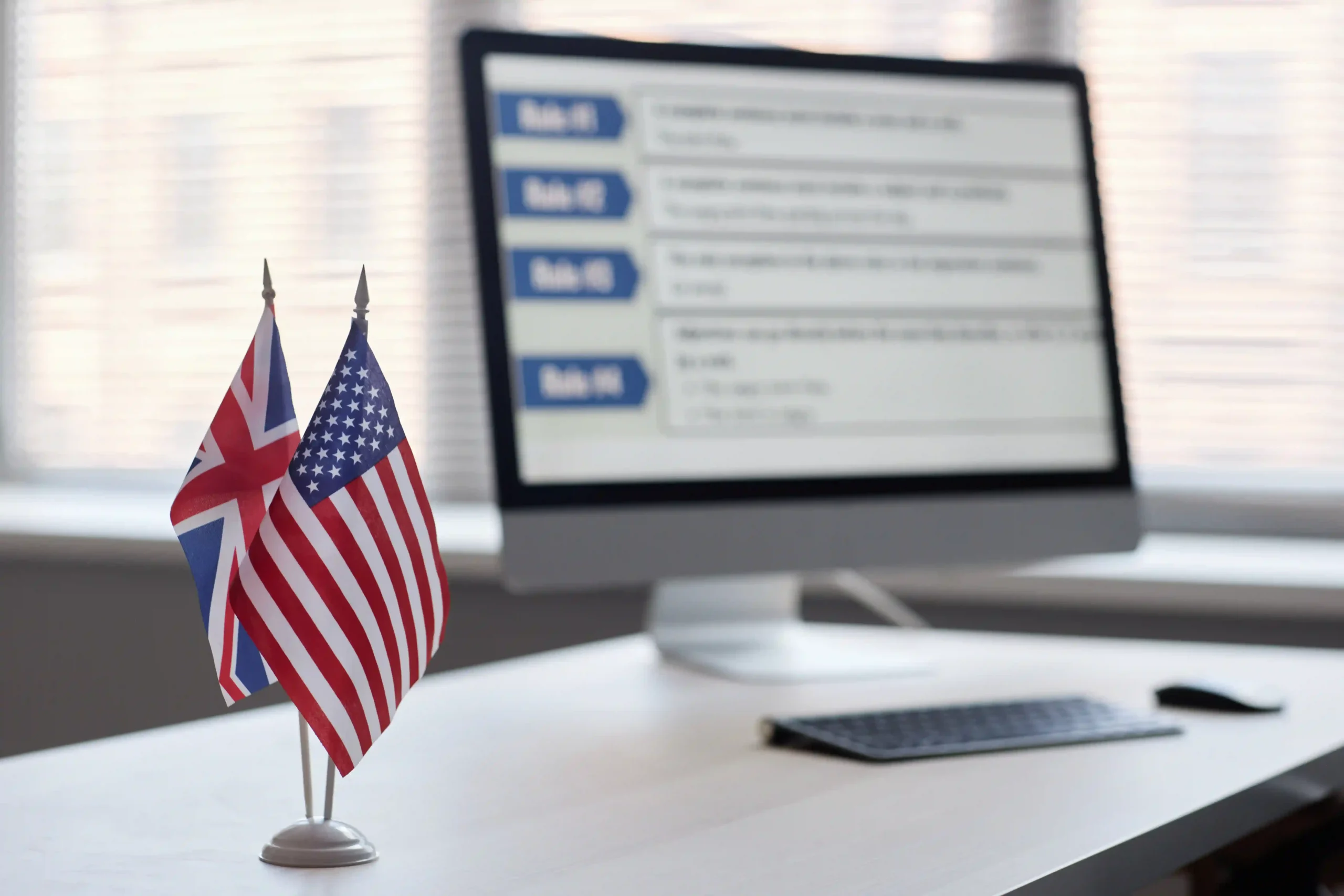 UK and U.S. flags on office desk symbolizing trade rules and compliance under de minimis UK to USA.