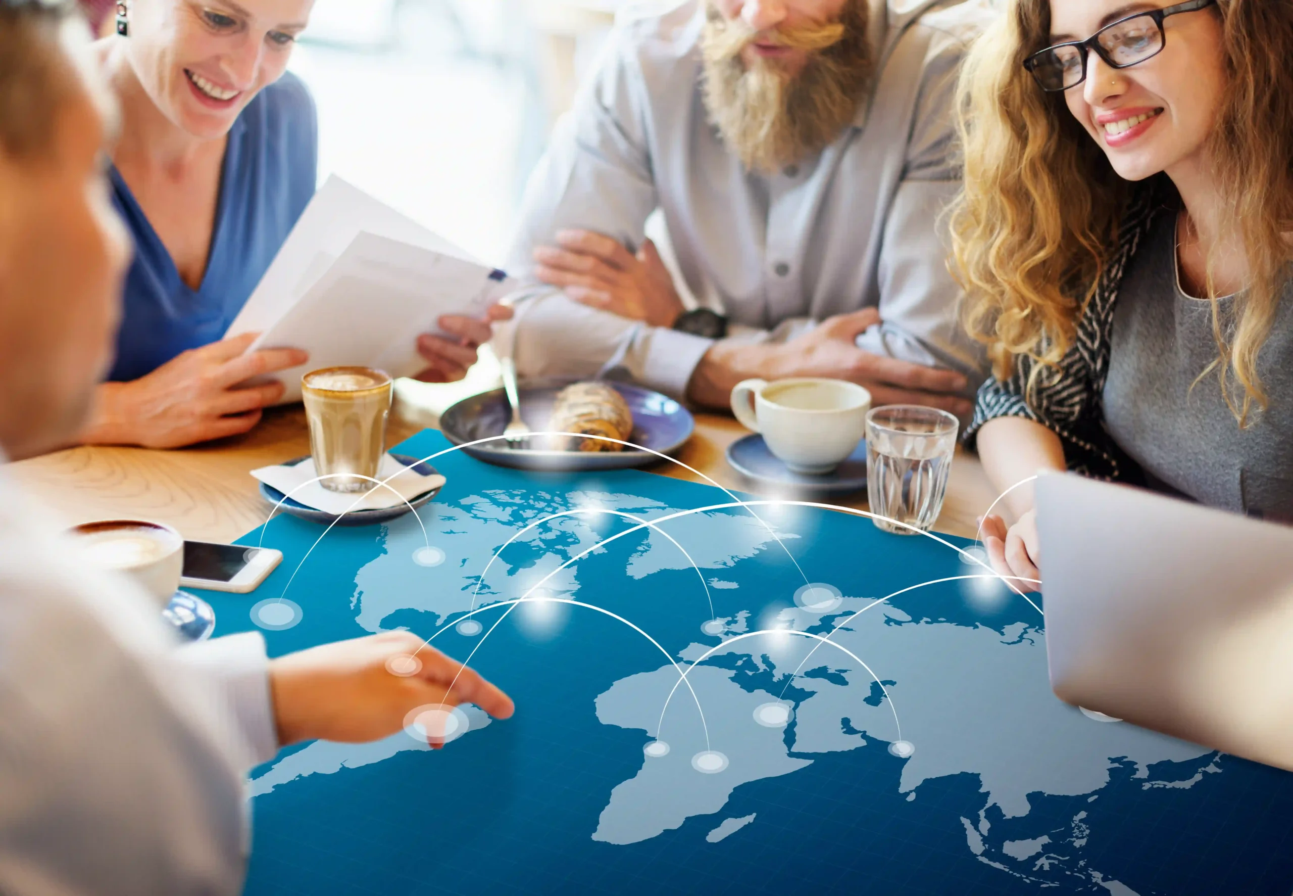 Business team planning international trade routes with world map, demonstrating how a de minimis waiver affects global commerce strategies.