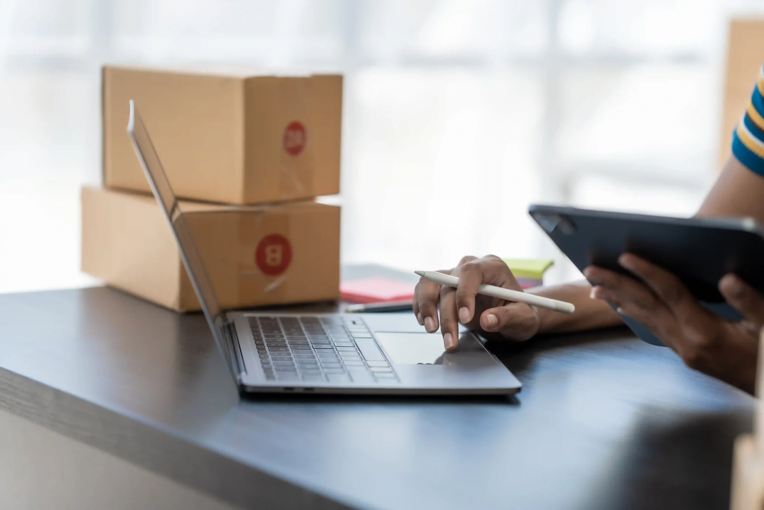 E-commerce entrepreneur reviewing invoices online and checking what is de minimis in tax for compliance.