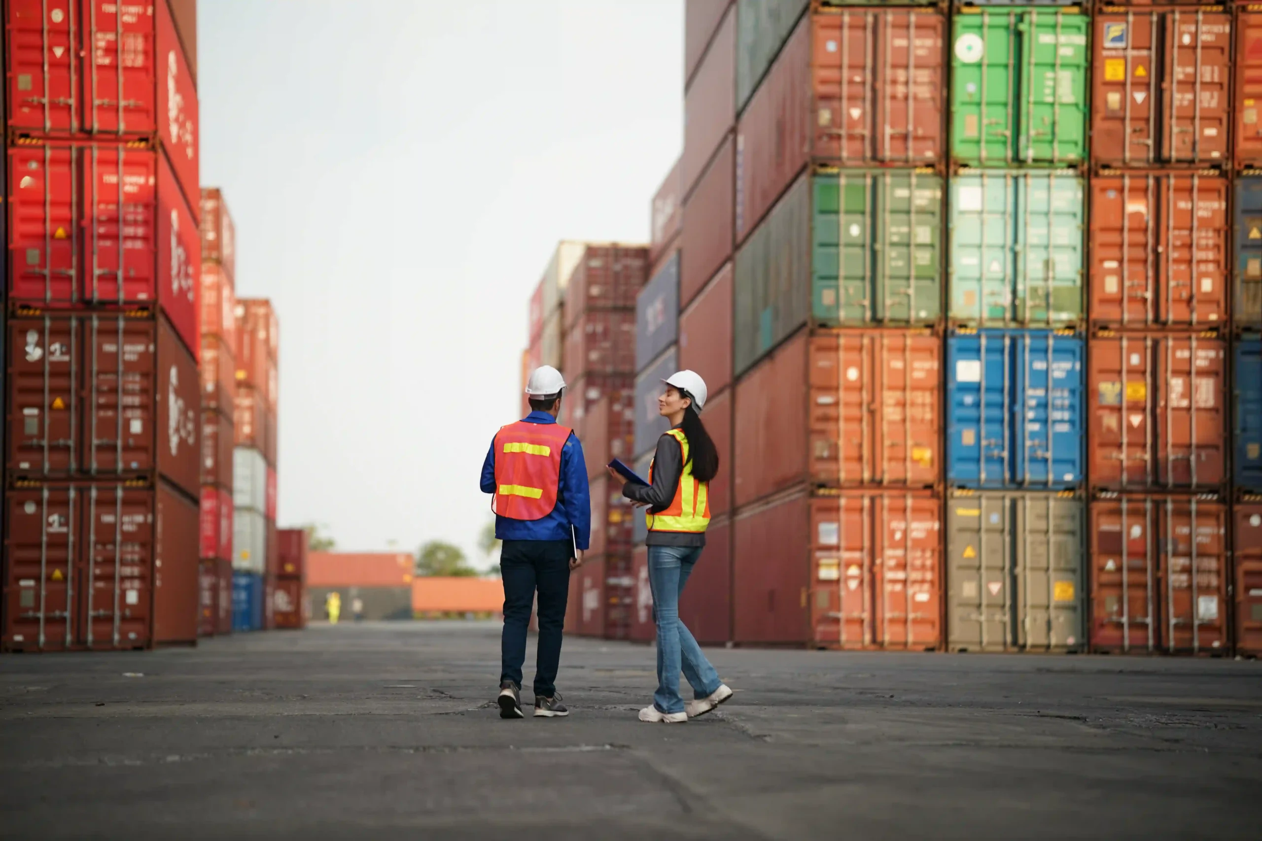 Trade professionals inspecting shipping containers, highlighting global customs thresholds and the de minimis doctrine.