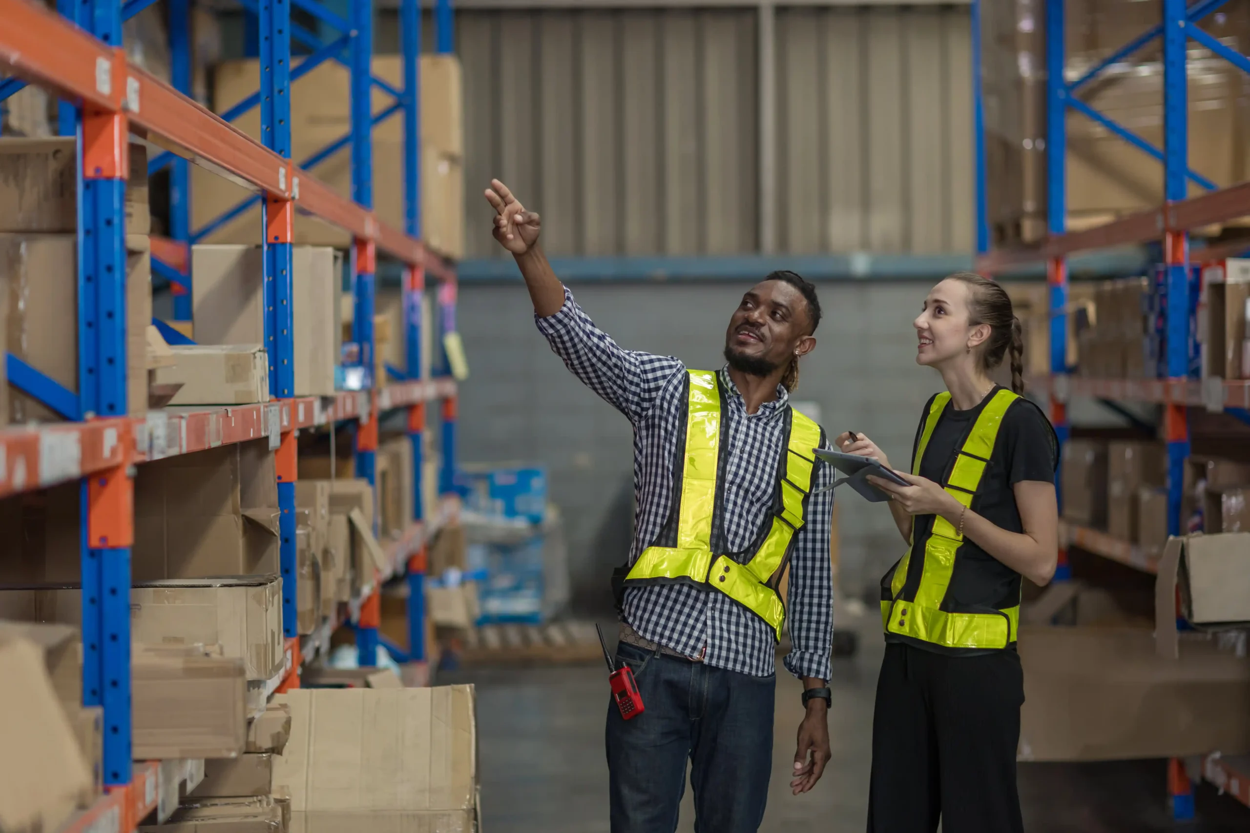 Warehouse staff reviewing items on racking systems, representing small warehouse ideas for organized storage and faster picking.