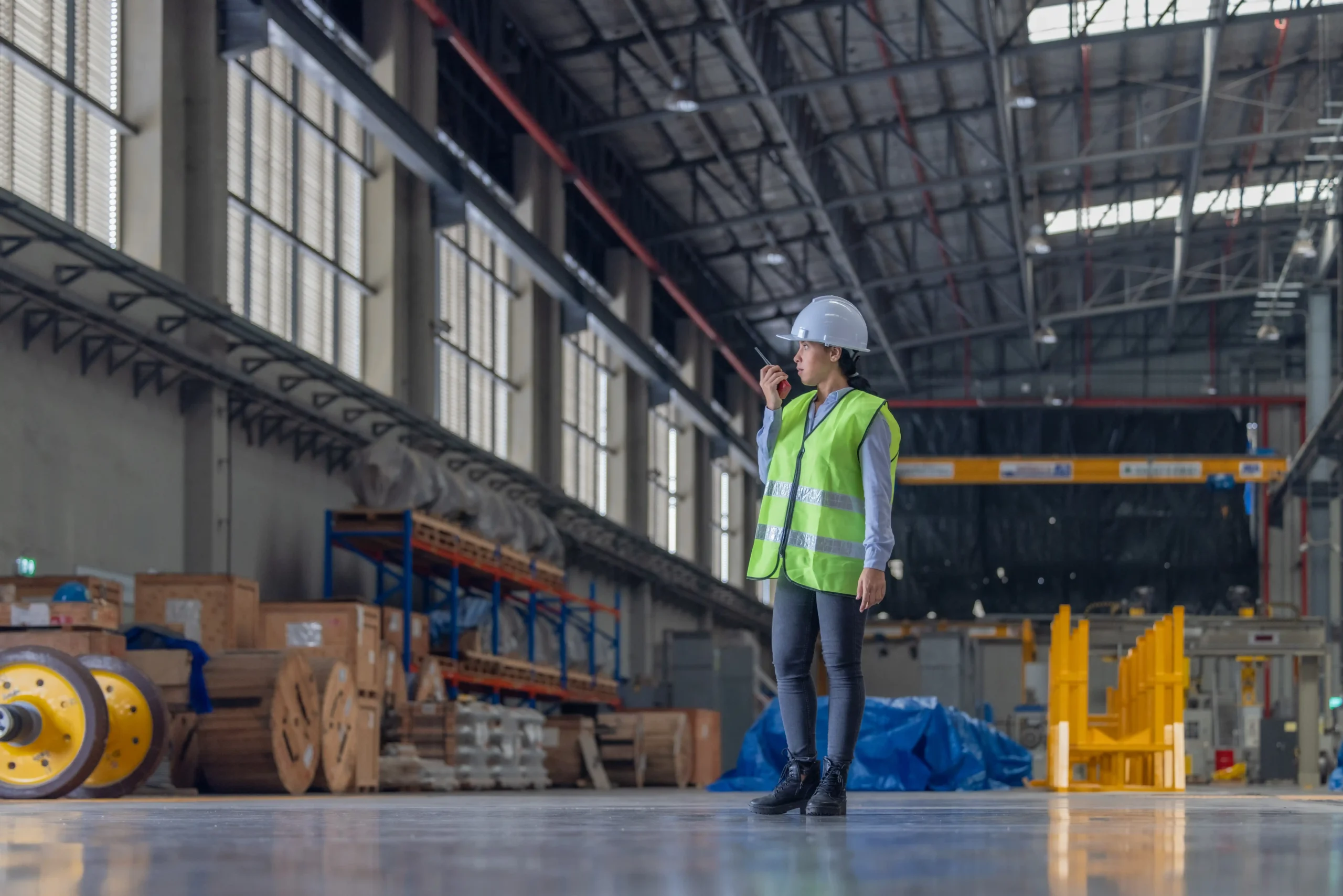 Warehouse manager inspecting warehouse zones and guiding operations inside a large industrial facility.