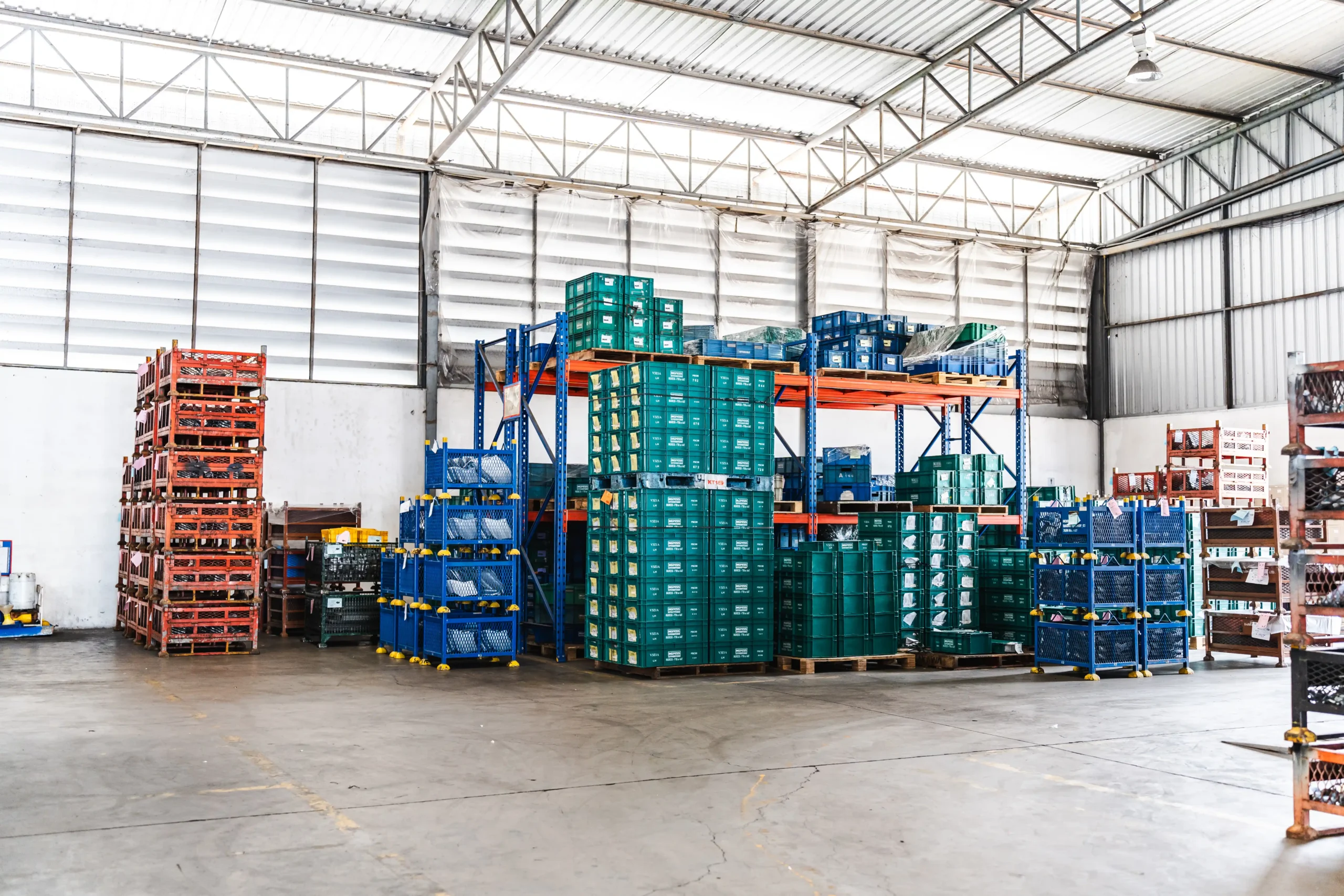 A warehouse with stacked crates and organized shelving showcasing small warehouse storage ideas that maximize space and efficiency.