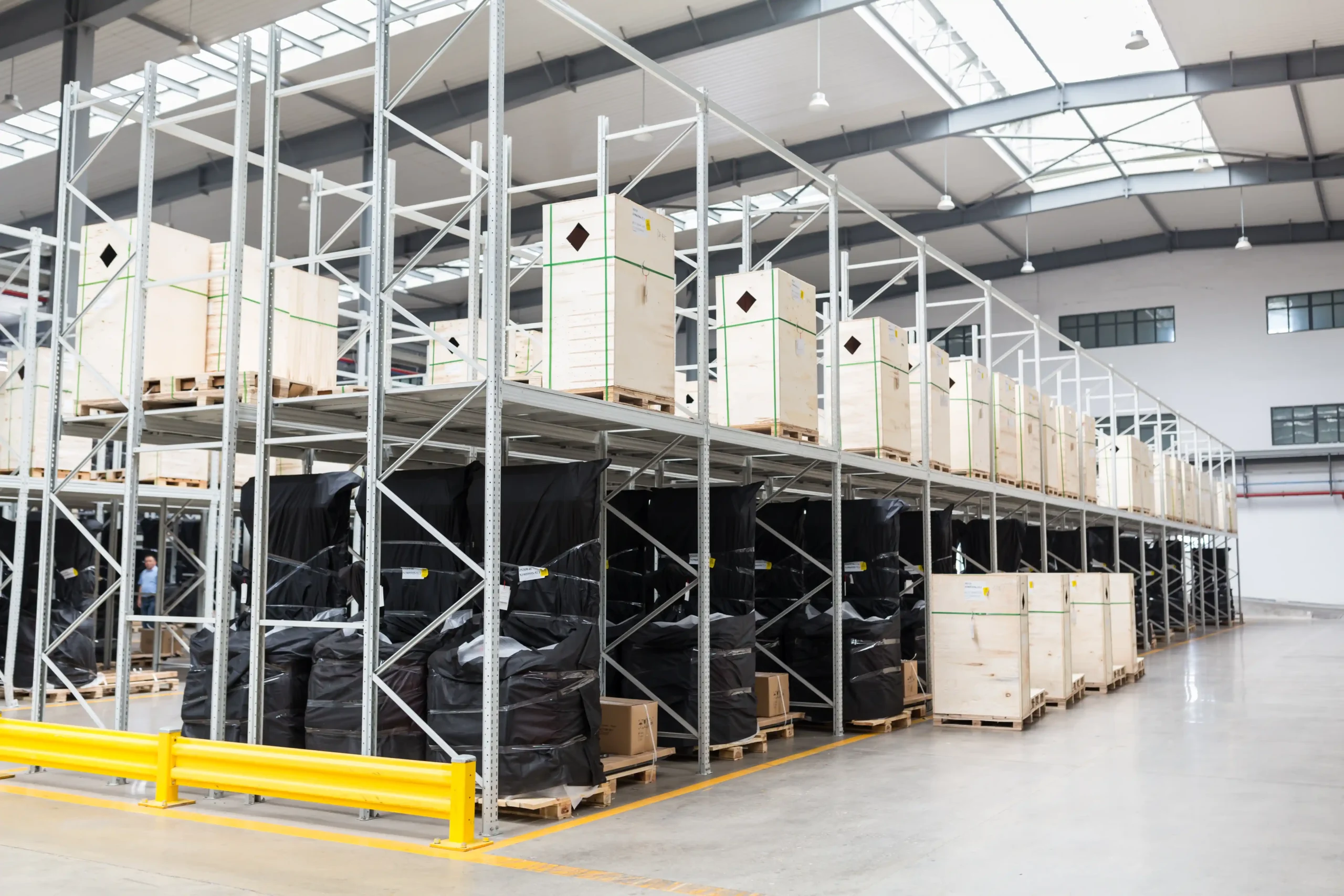 A modern warehouse with elevated shelving and palletized goods, highlighting industrial storage ideas that improve vertical capacity and workflow.