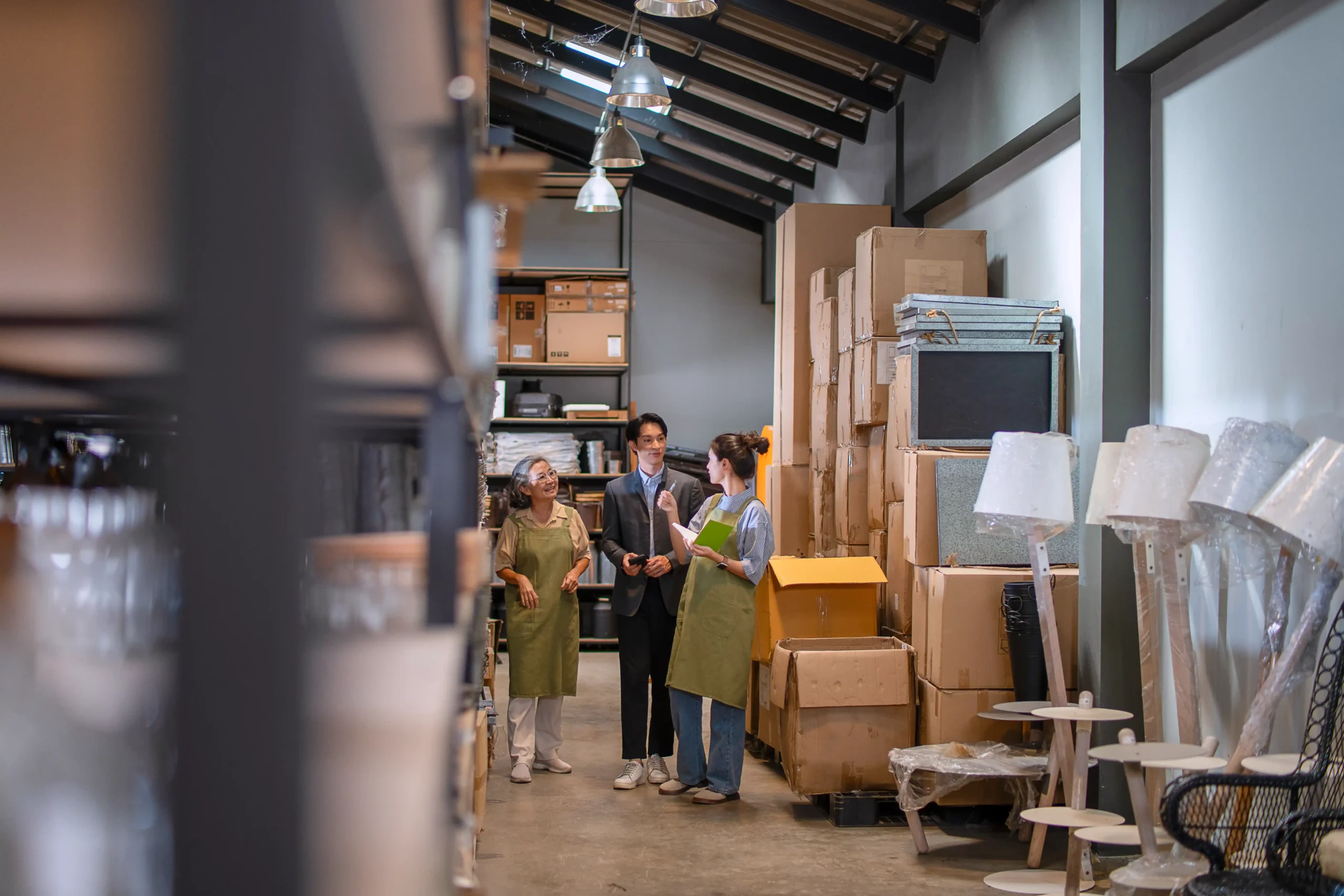 Small business team discussing inventory organization inside a facility providing small warehouse storage for rent.