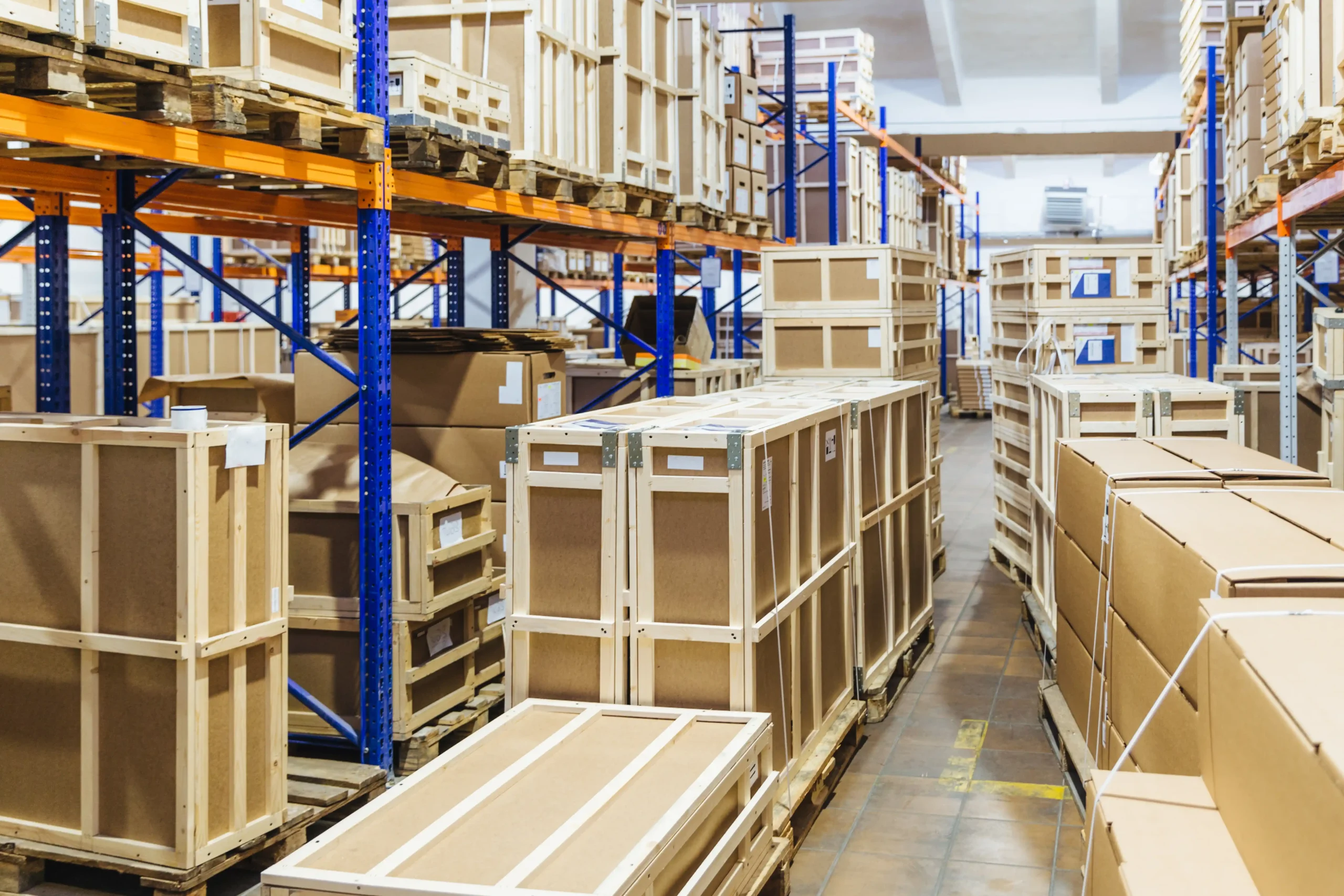 Well-organized warehouse shelving with boxed inventory showing how structured storage creates advantage warehouse and logistics efficiency.