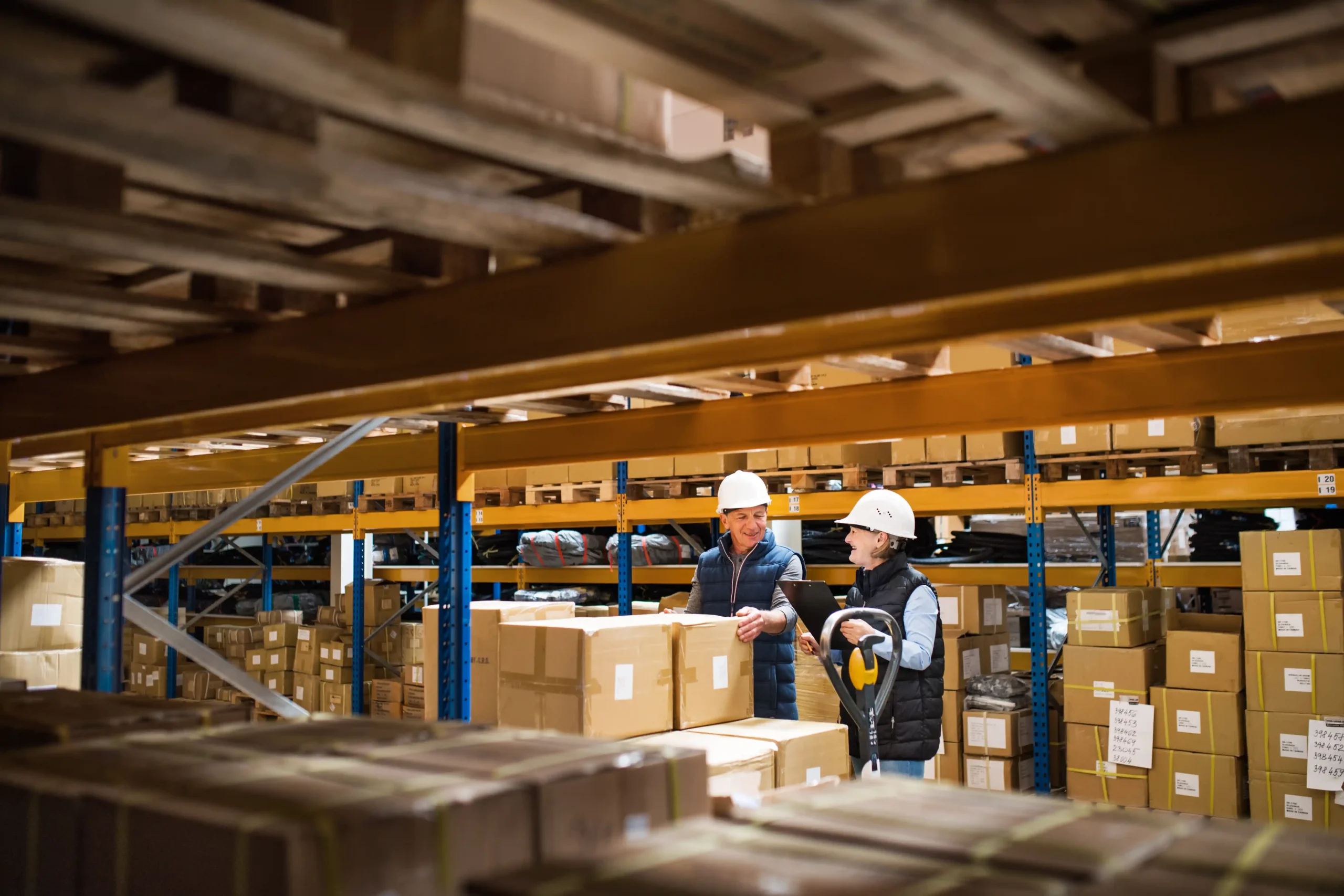 Supervisors reviewing pallets and inventory levels inside a warehouse storage Los Angeles facility.