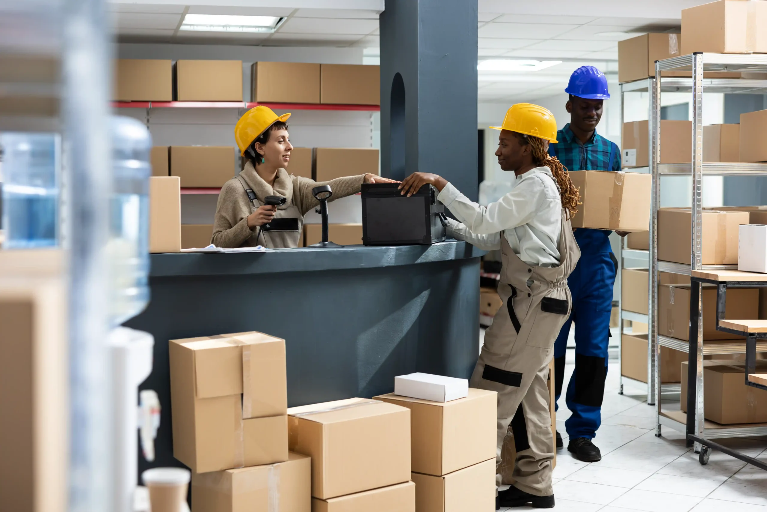 Diverse warehouse team scanning and organizing packages to support accurate inventory flow and essential kpi for warehouse and logistics.