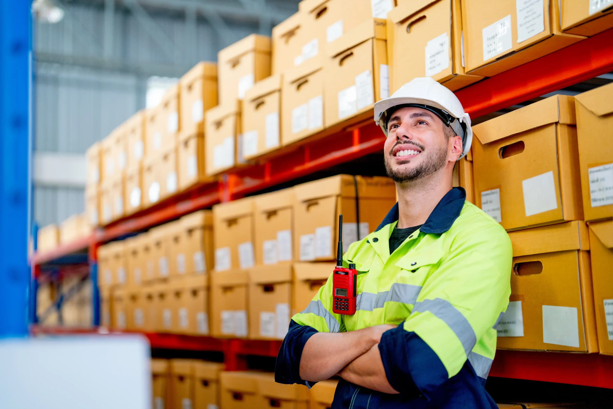 Warehouse and logistics specialist wearing safety equipment while coordinating inventory flow and warehouse logistics