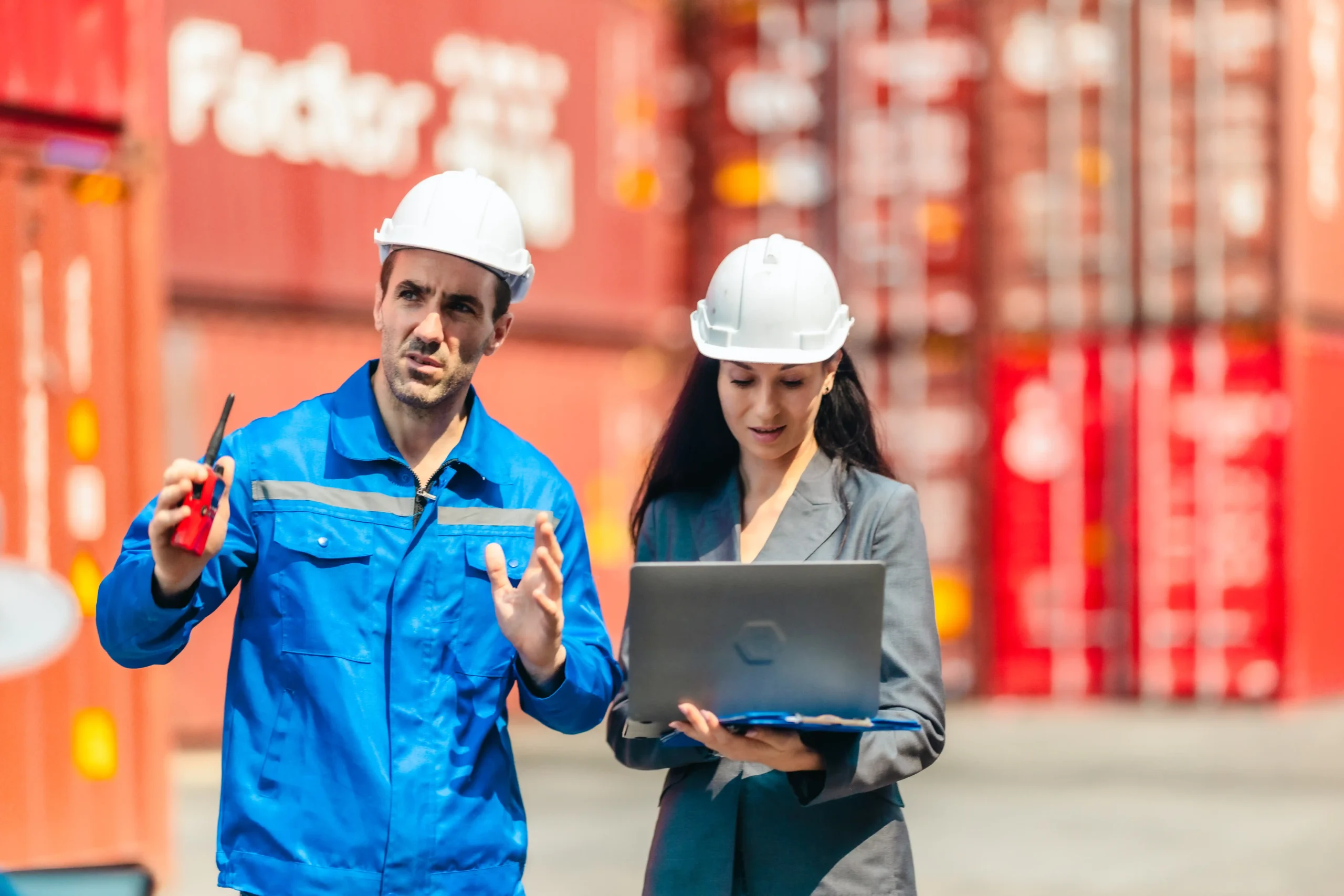 Logistics team using digital tools to plan container movements within a global warehouse and logistics environment