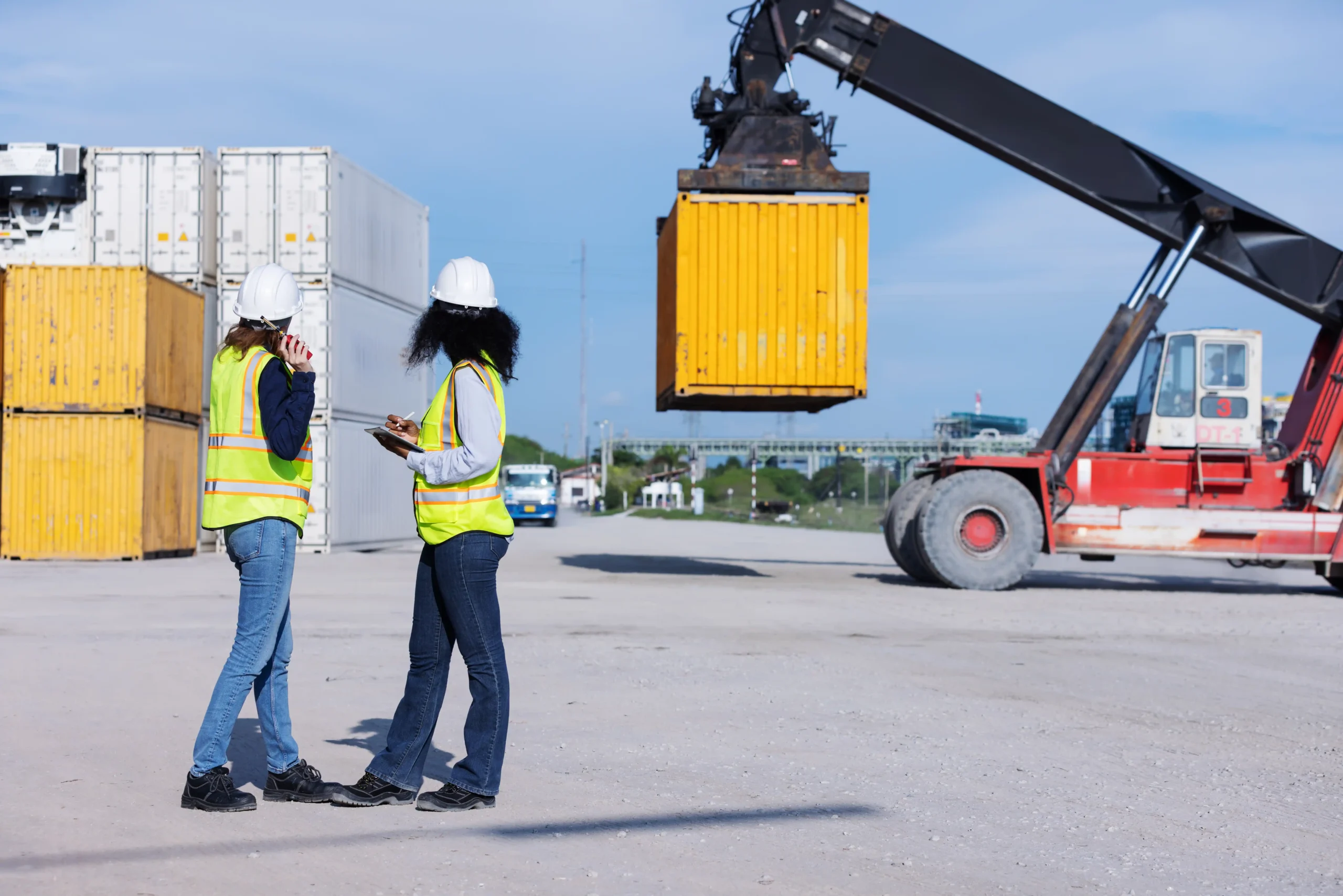 Logistics distribution managers reviewing warehouse operations that influence logistics distribution manager salary growth