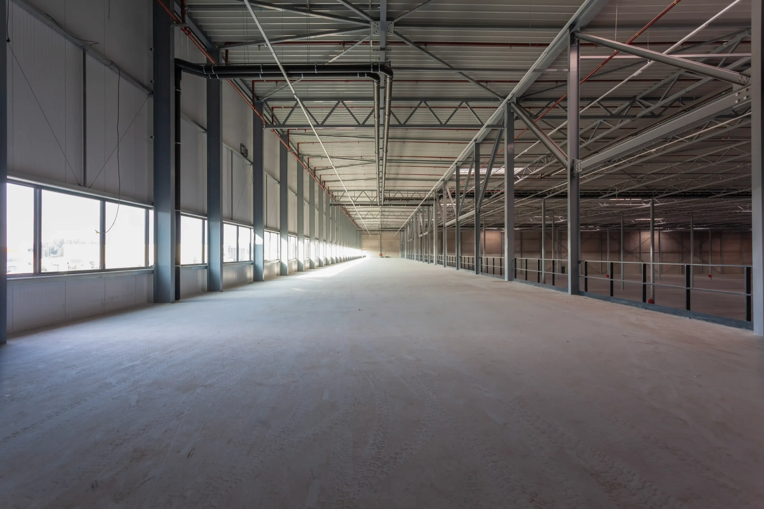 View from the mezzanine level of a newly built warehouse, illustrating vertical capacity available in small warehouse units for rent.