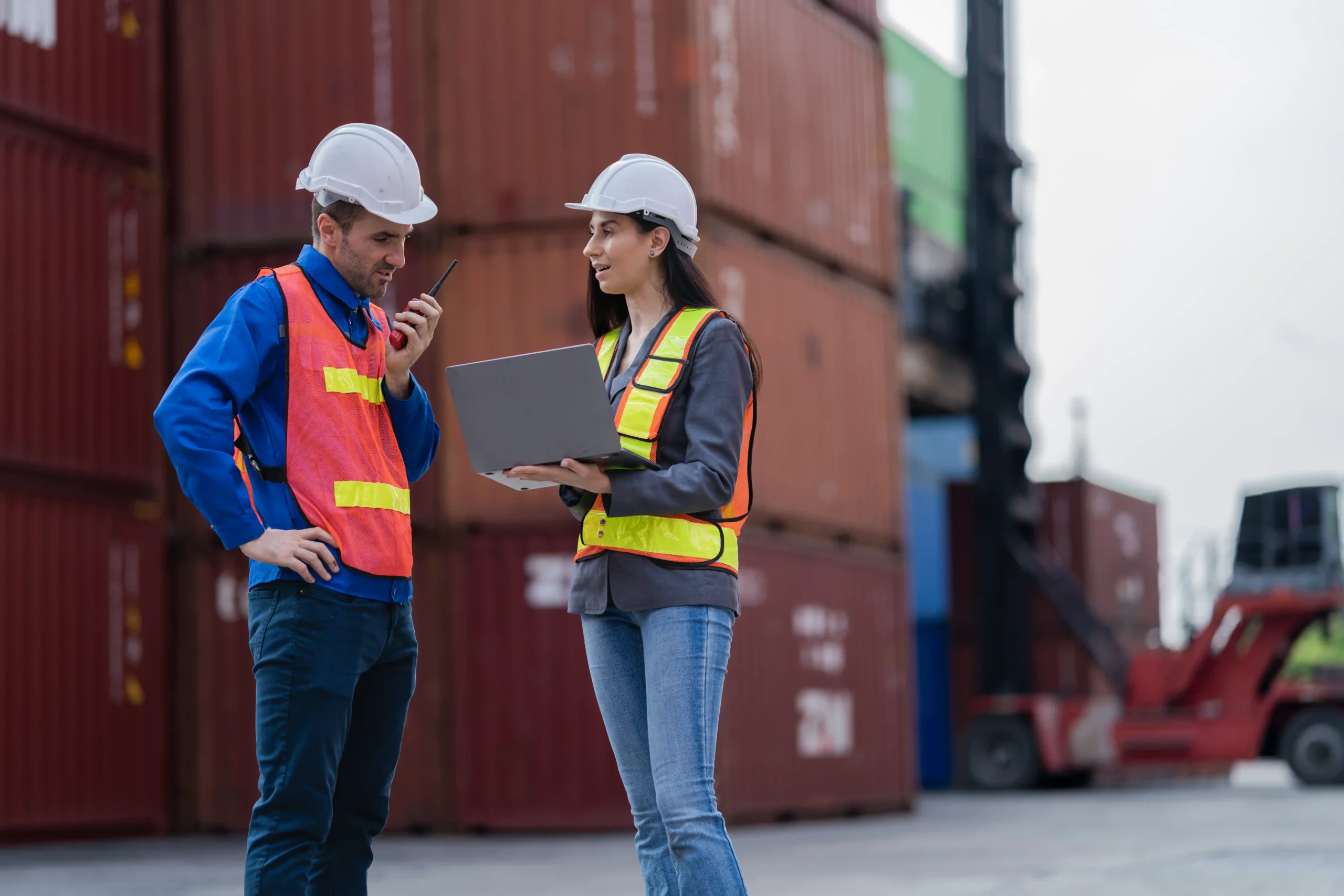 Logistics distribution managers coordinating warehouse teams and safety procedures that affect salary and responsibility